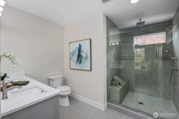 a bathroom with a toilet a sink and shower