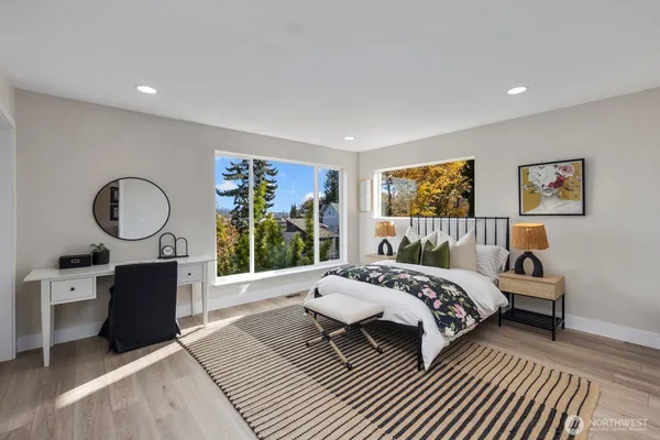 a bedroom with a large bed and a large window