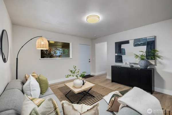 a living room with furniture and wooden floor