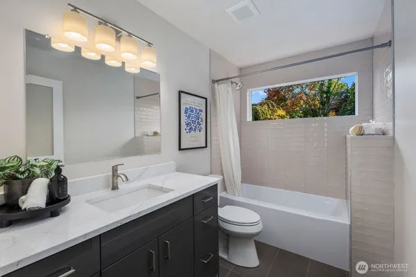 a bathroom with a sink a toilet and a bathtub