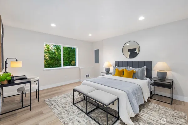 a bedroom with a bed a dresser and a window