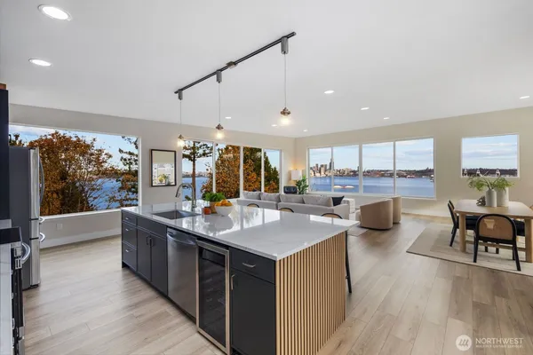 a kitchen with counter top space a sink cabinets and wooden floor