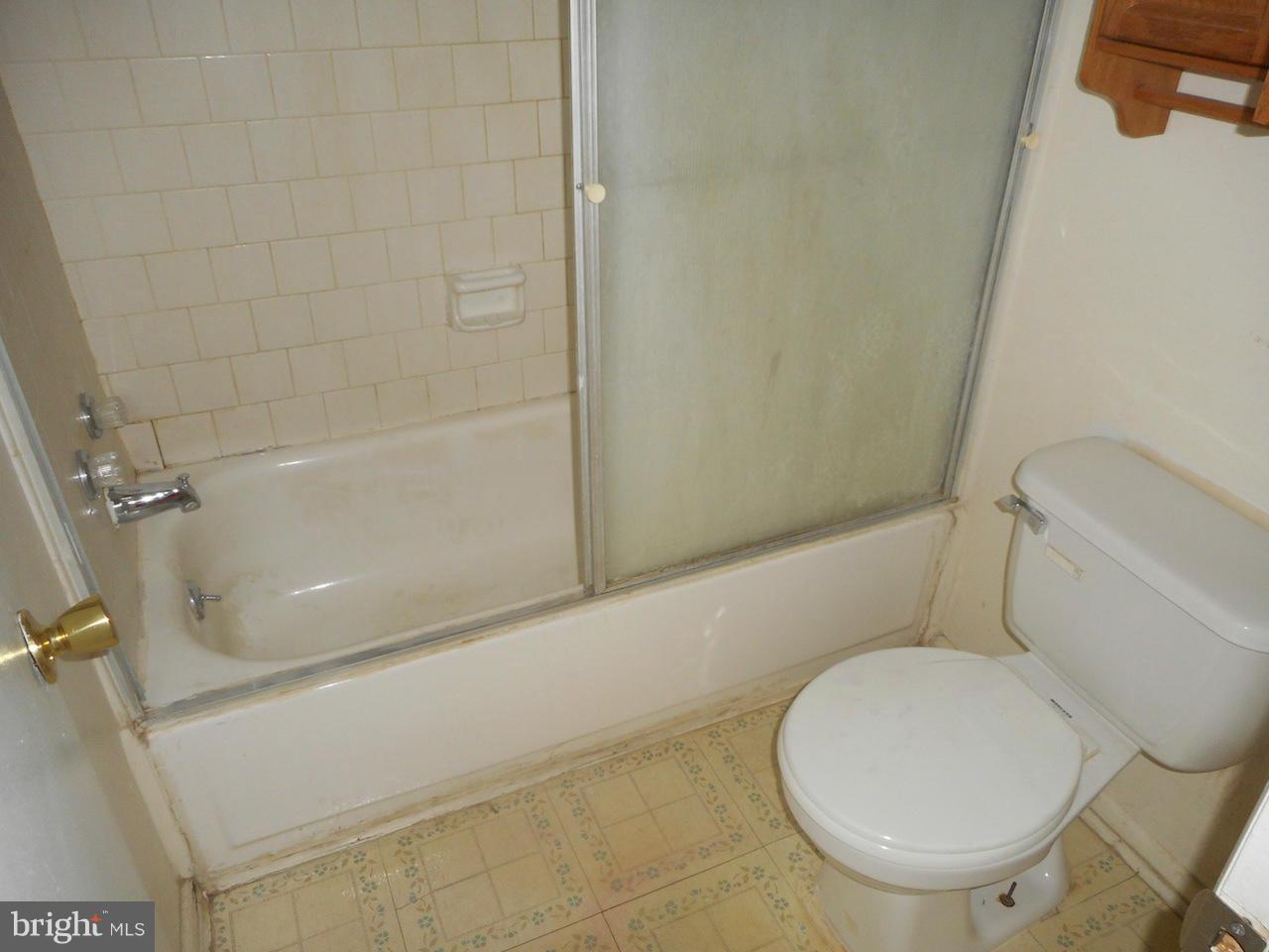 17518 Hoskinson Road Poolesville, MD 20837 - Photo 19 of 22 a white toilet sitting next to a bath tub