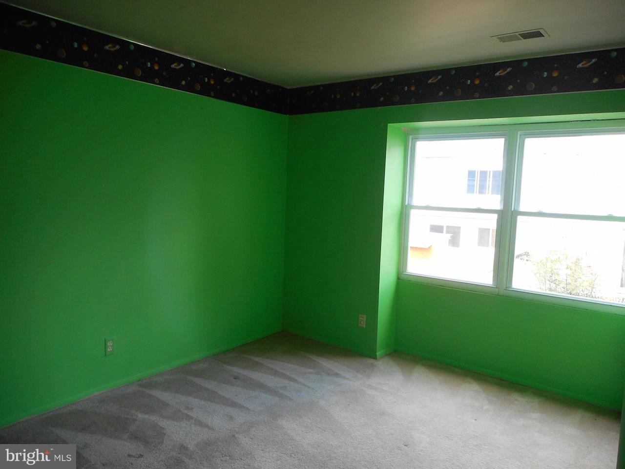 17518 Hoskinson Road Poolesville, MD 20837 - Photo 21 of 22 a view of an empty room with a window and a ceiling fan
