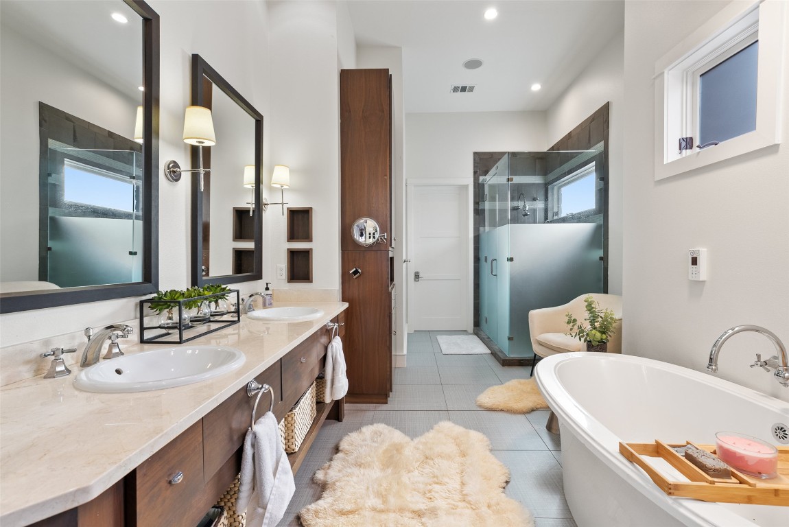 7025 Cielo Azul Pass Austin, TX 78732 - Photo 16 of 35 a bathroom with a tub sink and mirror