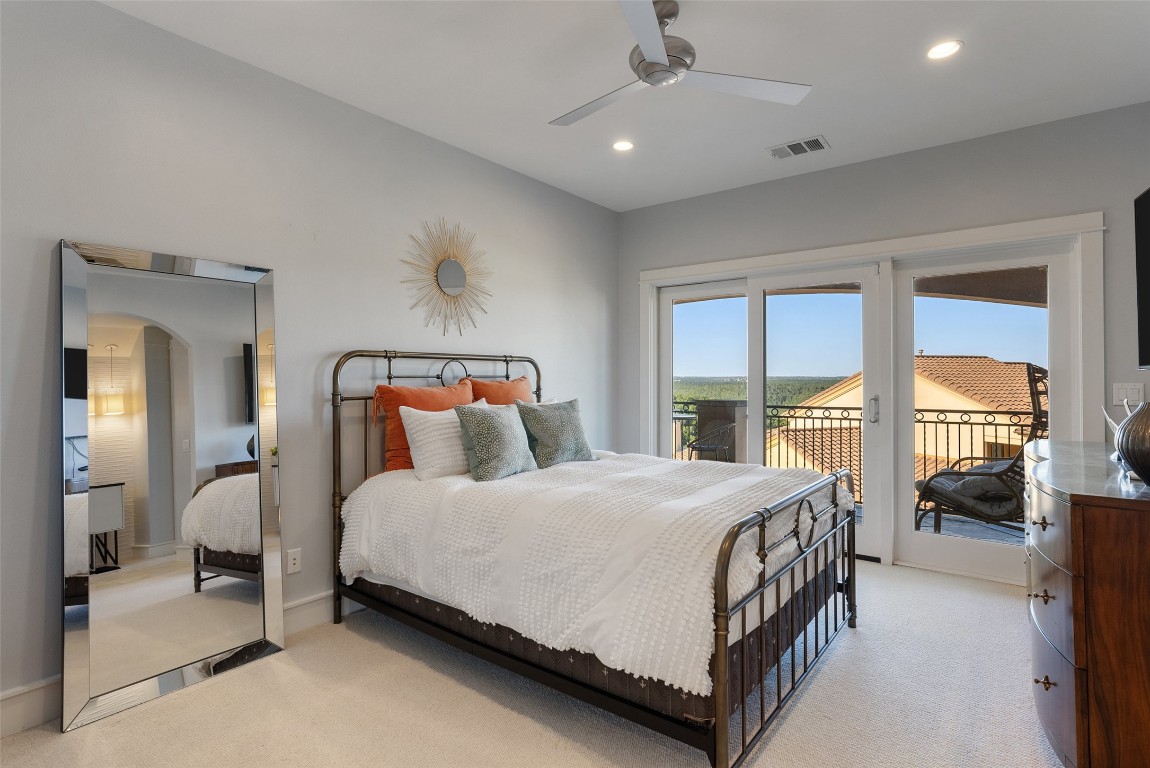 7025 Cielo Azul Pass Austin, TX 78732 - Photo 18 of 35 a bedroom with a bed couch and a large window