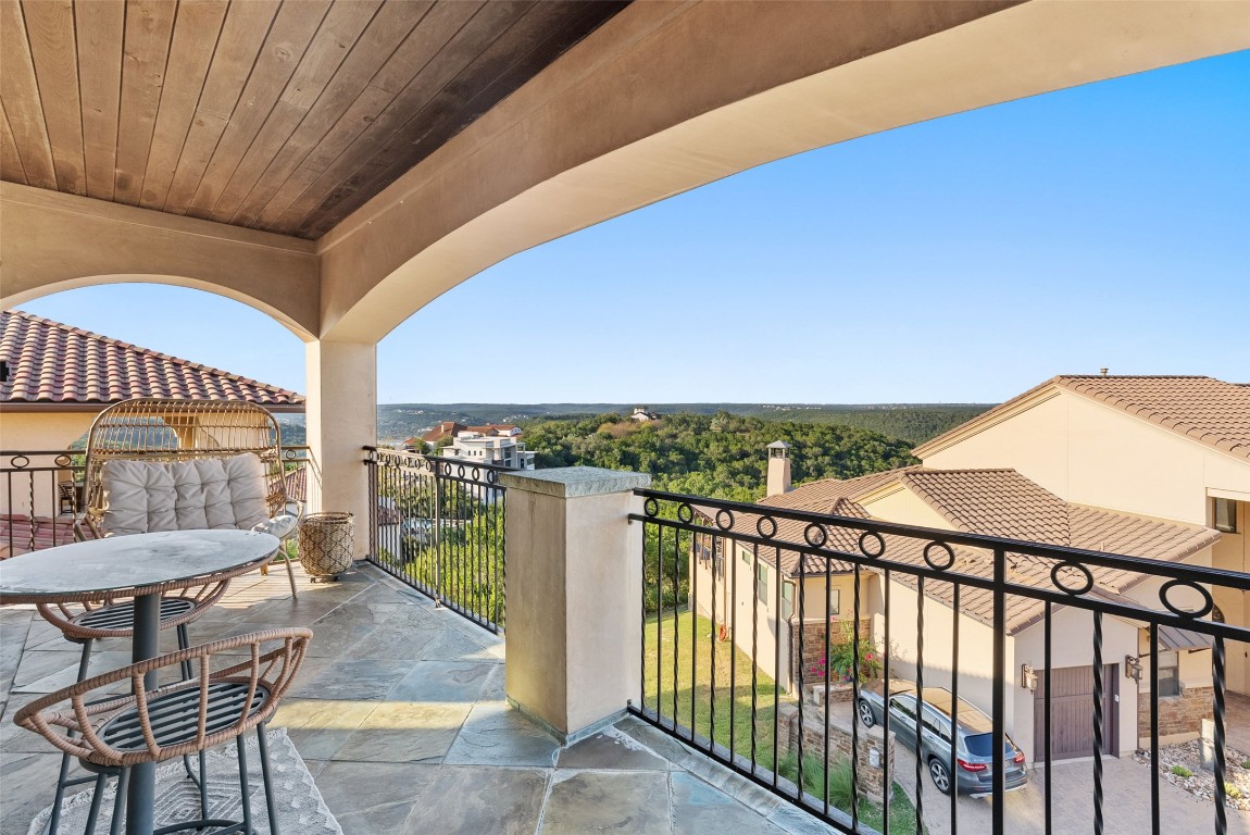 7025 Cielo Azul Pass Austin, TX 78732 - Photo 20 of 35 a view of a balcony with furniture and a floor to ceiling window
