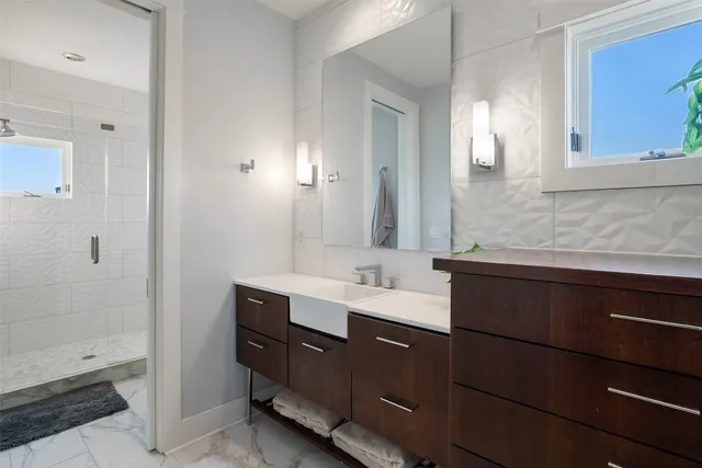 a bathroom with a double vanity sink and mirror