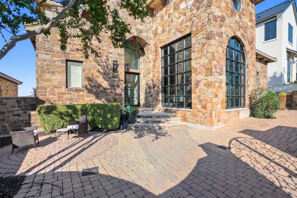 7025 Cielo Azul Pass Austin, TX 78732 - Photo 29 of 35 a view of a brick building next to a yard