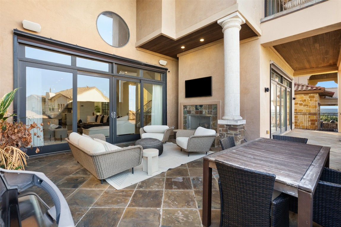 7025 Cielo Azul Pass Austin, TX 78732 - Photo 30 of 35 a living room with furniture a large window and a flat screen tv