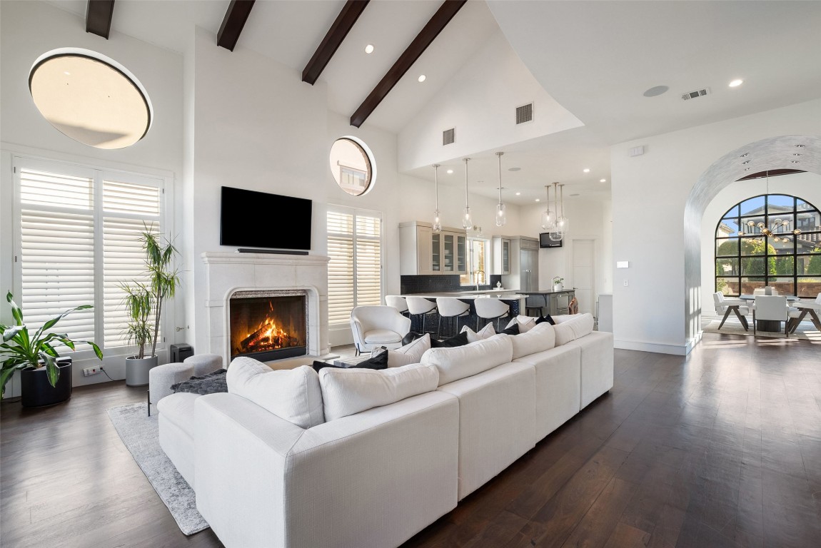 7025 Cielo Azul Pass Austin, TX 78732 - Photo 5 of 35 a living room with furniture a fireplace and a flat screen tv
