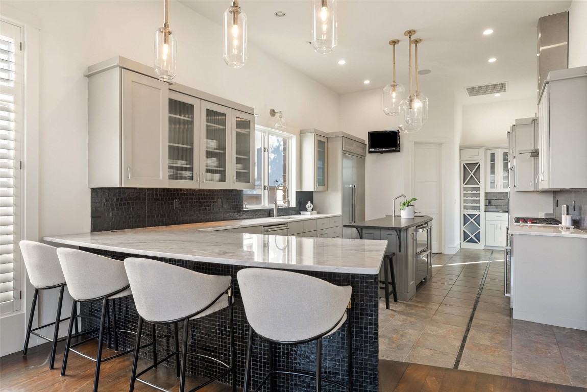 7025 Cielo Azul Pass Austin, TX 78732 - Photo 10 of 35 a kitchen with kitchen island stainless steel appliances a sink and cabinets