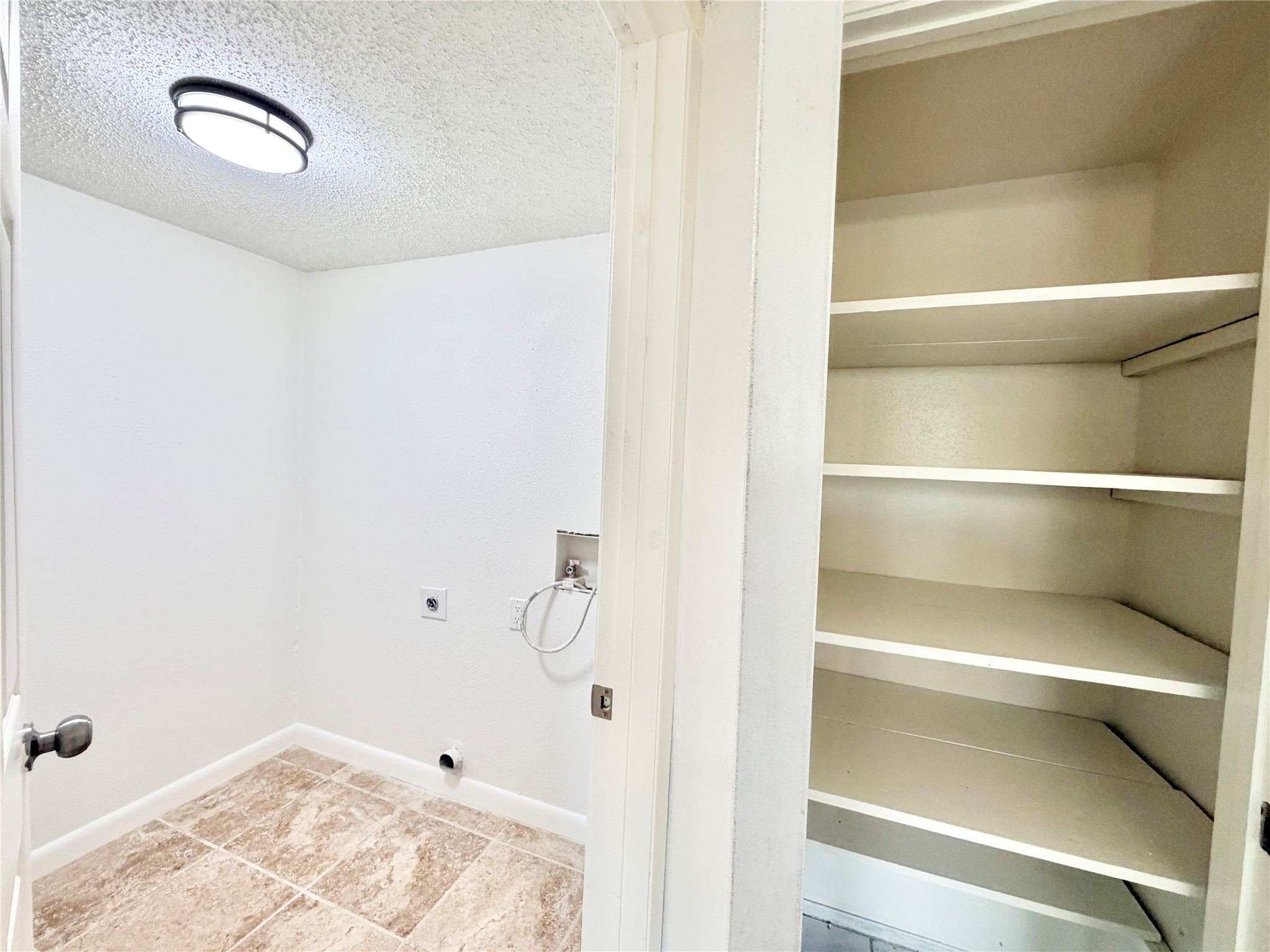 9623 Covey Ridge Lane Austin, TX 78758 - Photo 18 of 40 Laundry room with a textured ceiling, washer hookup, and hookup for an electric dryer