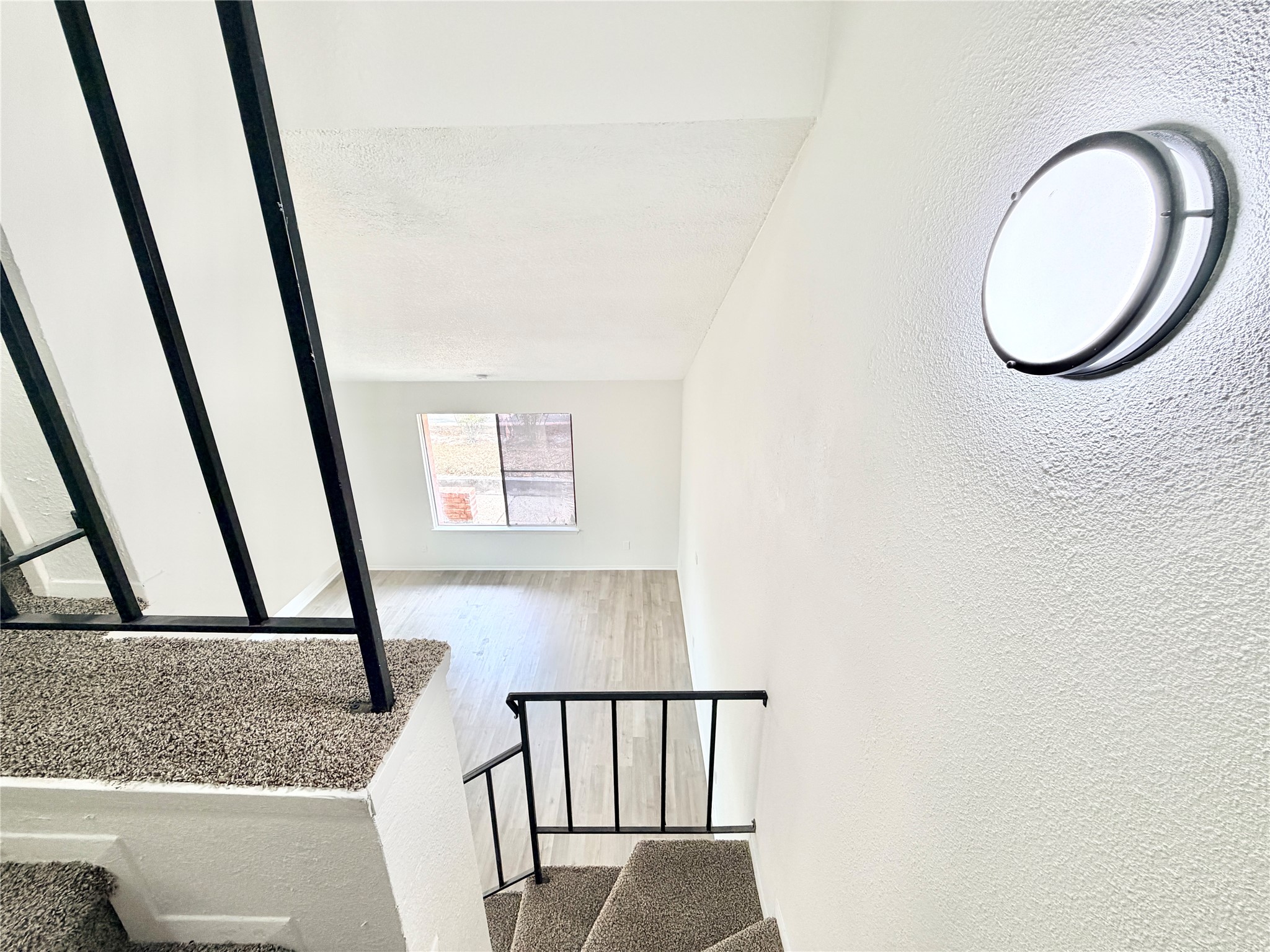 9623 Covey Ridge Lane Austin, TX 78758 - Photo 21 of 40 Staircase with a textured wall and wood finished floors