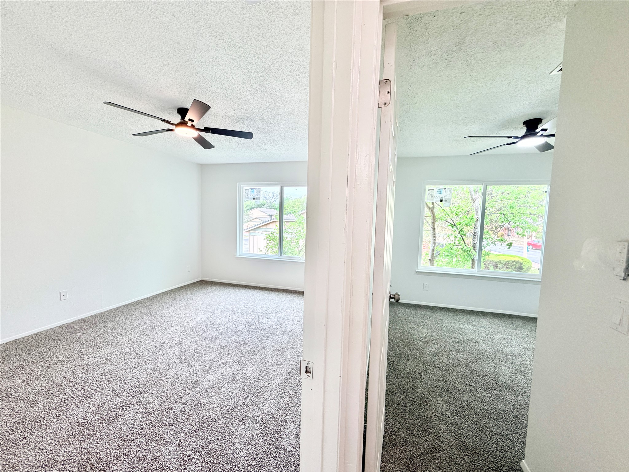 9623 Covey Ridge Lane Austin, TX 78758 - Photo 25 of 40 Empty room with a ceiling fan, carpet floors, and a textured ceiling