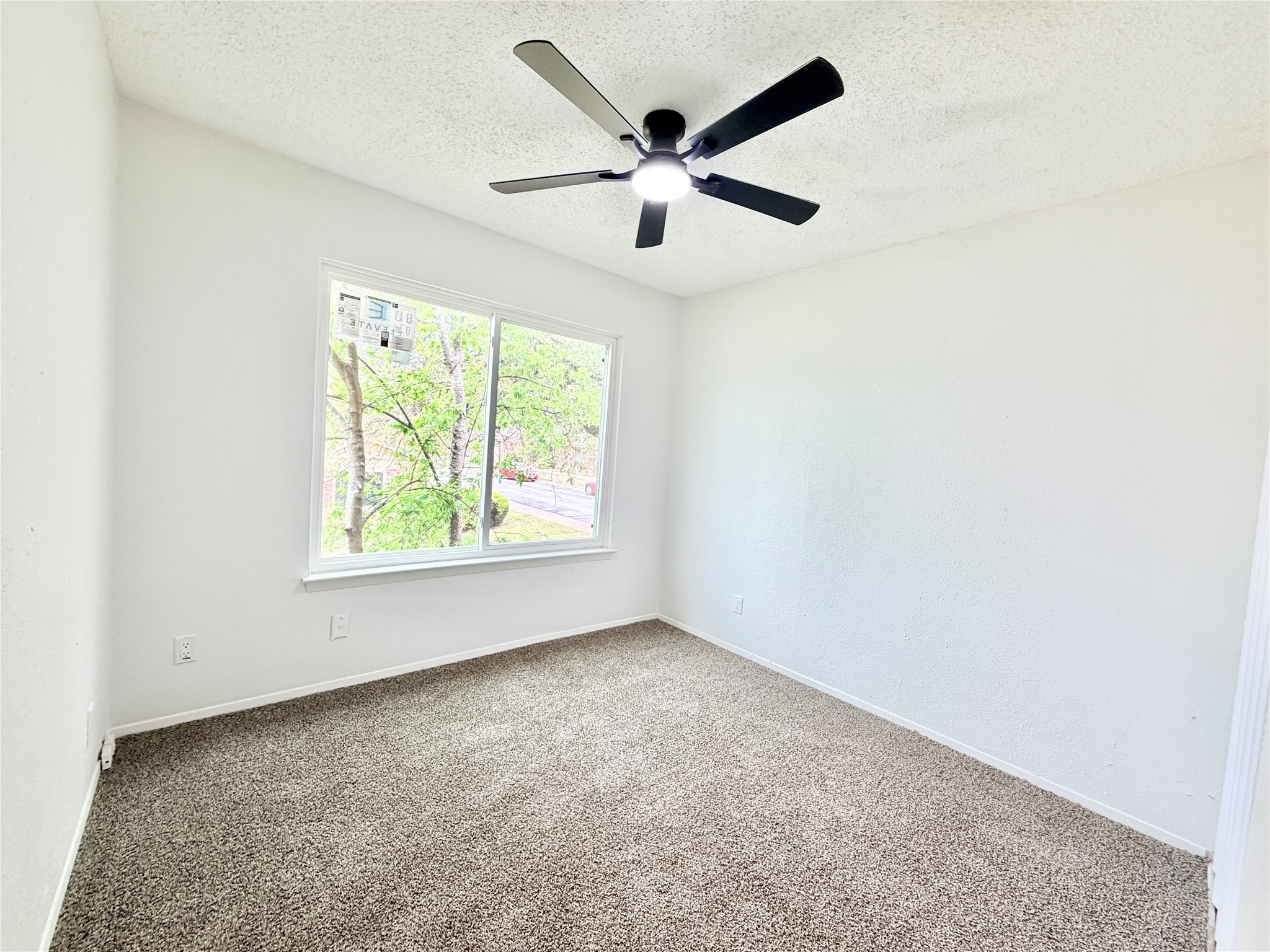 9623 Covey Ridge Lane Austin, TX 78758 - Photo 26 of 40 Carpeted empty room with a textured ceiling and a ceiling fan