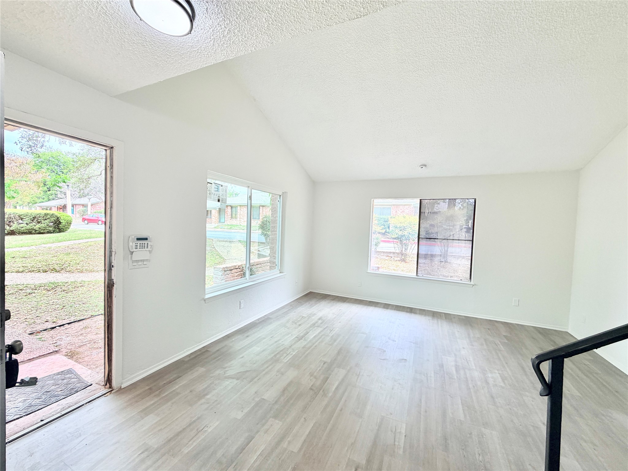 9623 Covey Ridge Lane Austin, TX 78758 - Photo 6 of 40 Unfurnished living room featuring light wood-type flooring and baseboards