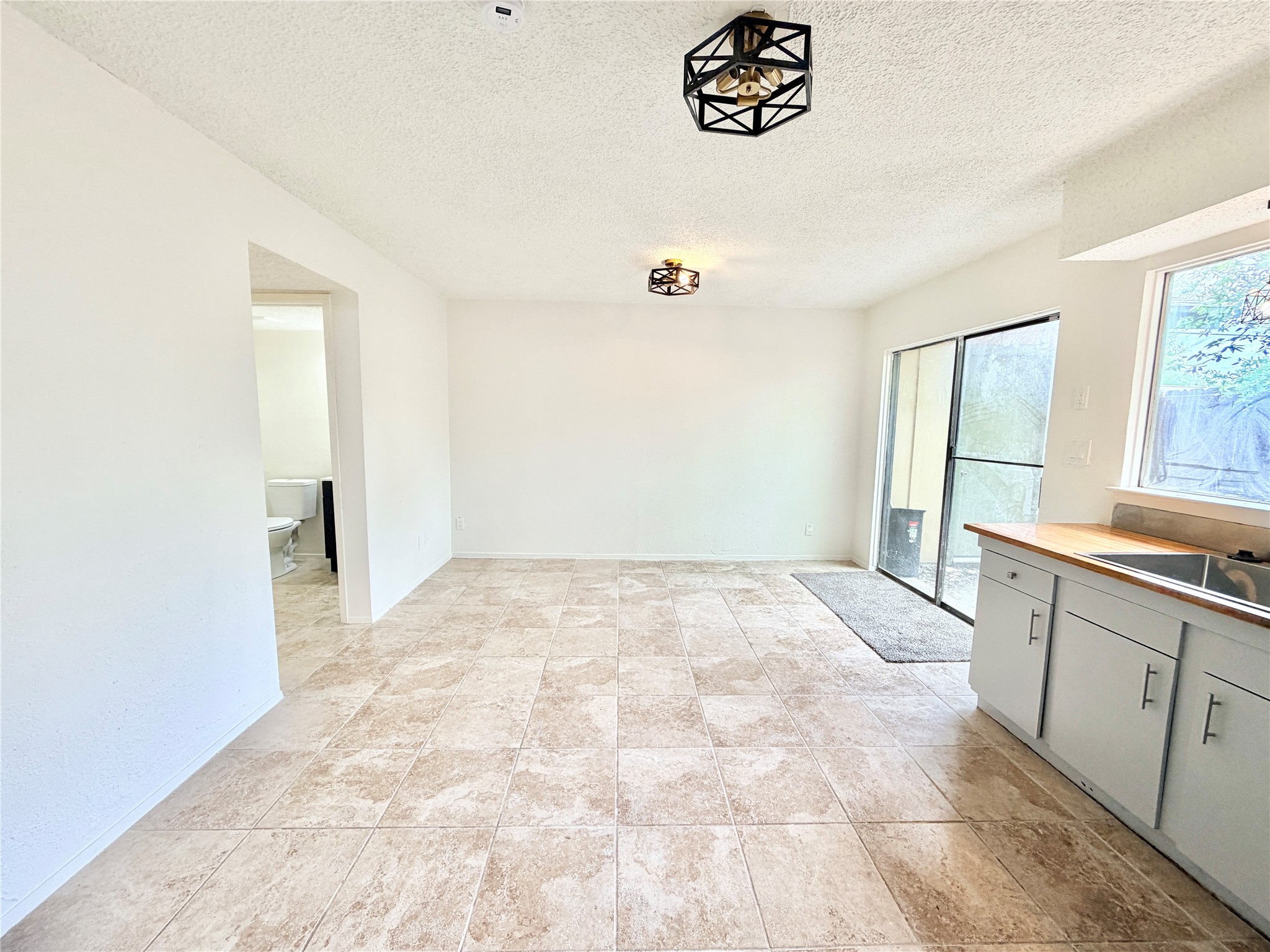 9623 Covey Ridge Lane Austin, TX 78758 - Photo 10 of 40 Unfurnished dining area featuring a textured ceiling