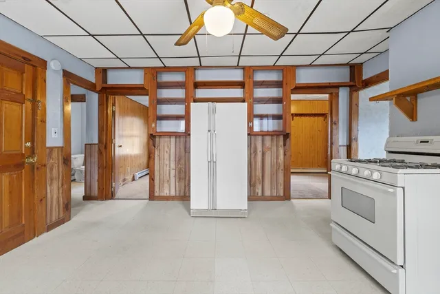 a view of a hallway with entryway and chandelier
