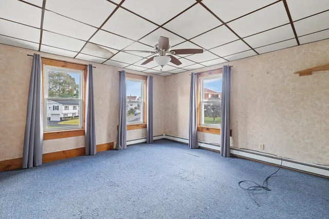 a view of empty room with ceiling fan