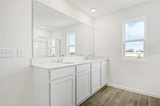 a bathroom with a glass shower door
