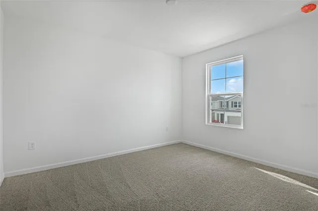 a view of a house with a yard and a large tree