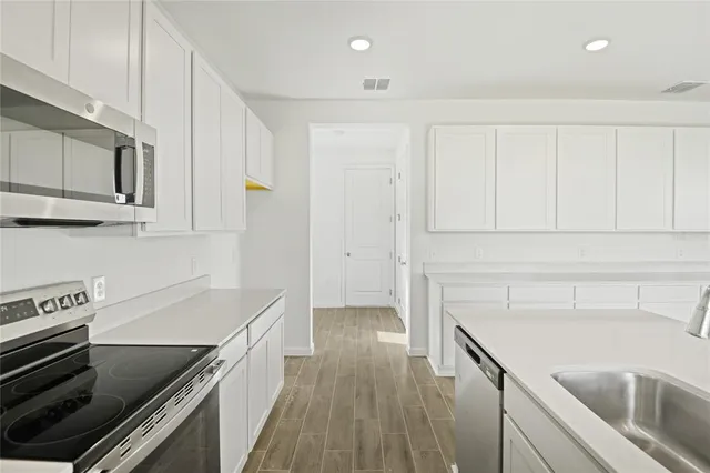 a kitchen with a stove and a microwave