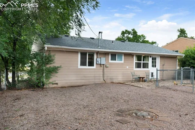a house that has a tree in front of it