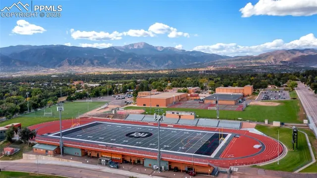 an aerial view of a pool patio swimming pool and mountain view