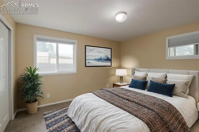 a bedroom with a bed and a potted plant