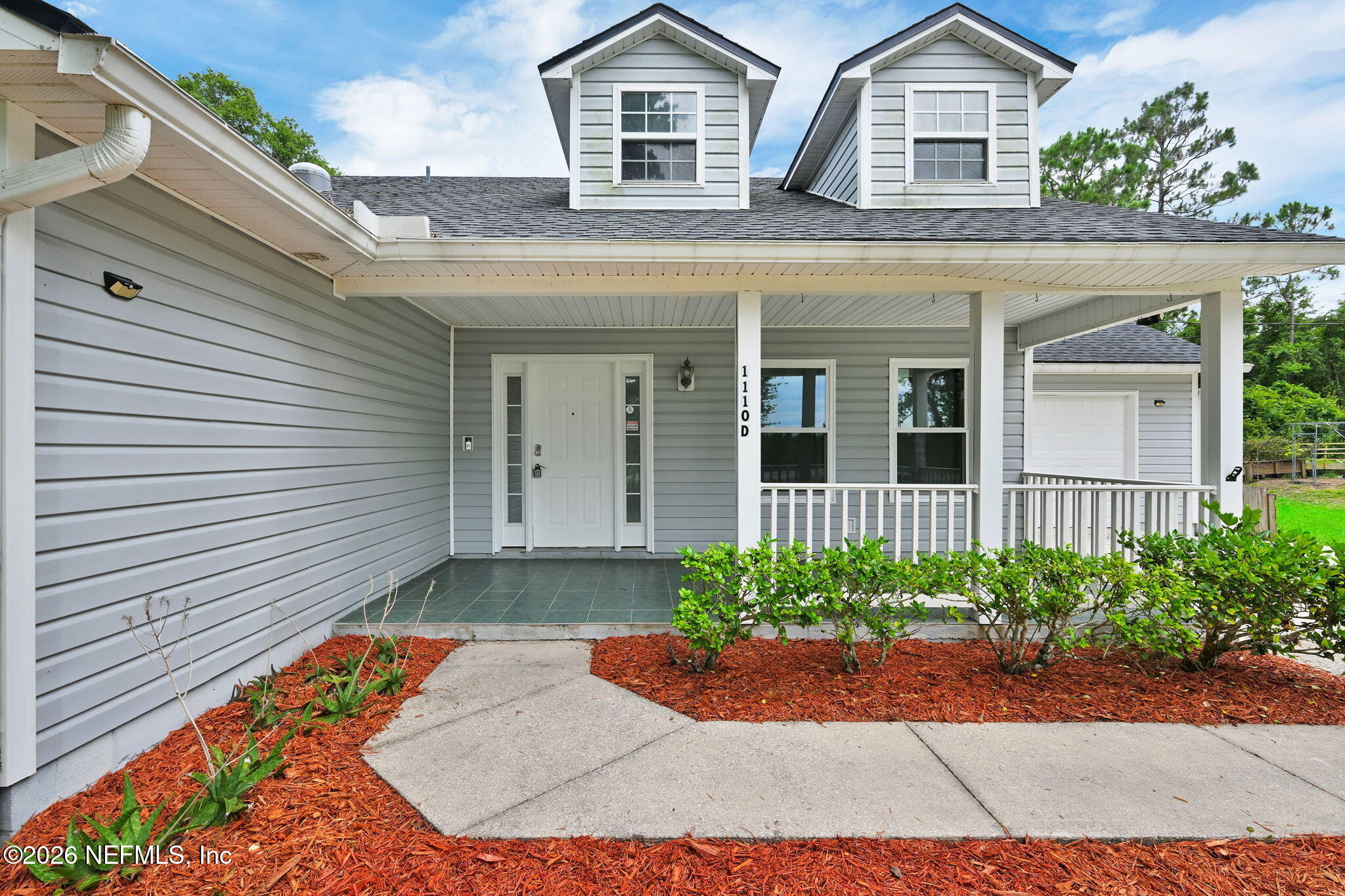 1110 Woodlawn Road, Unit D St. Augustine, FL 32084 - Photo 6 of 40 a front view of a house with garden