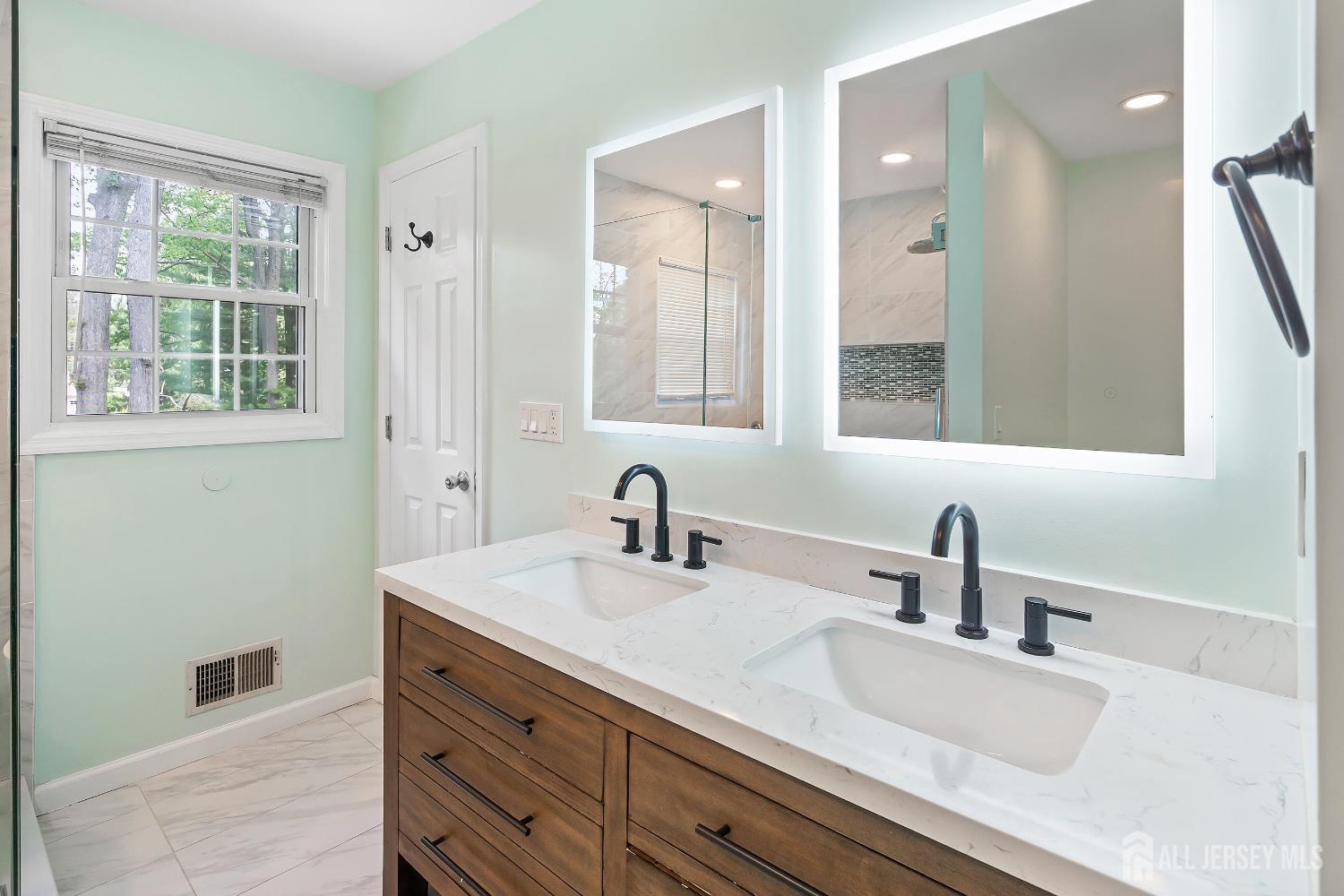 10 Woodruff Road Edison, NJ 08820 - Photo 12 of 18 a bathroom with a sink and a mirror