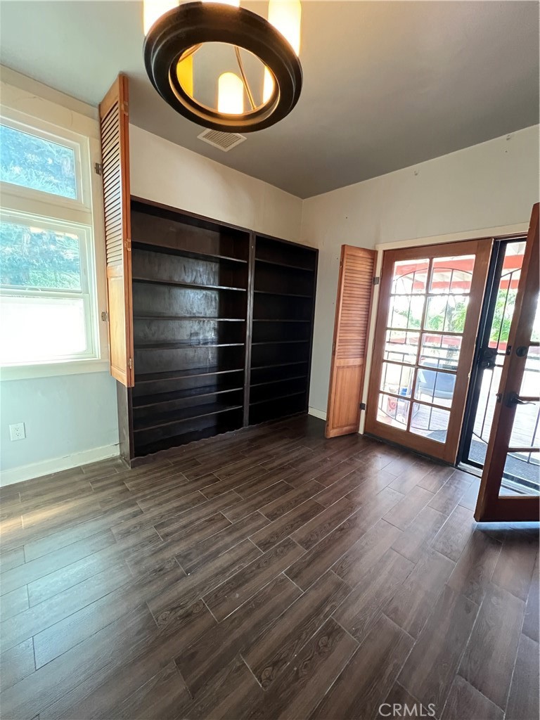 10568 Foothill Boulevard Sylmar, CA 91342 - Photo 12 of 34 an empty room with wooden floor and windows