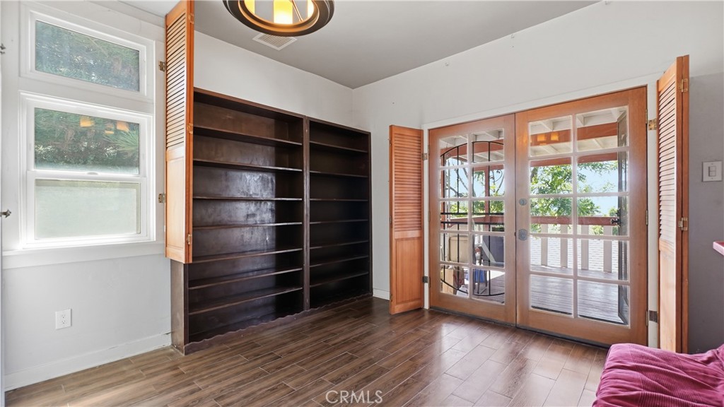 10568 Foothill Boulevard Sylmar, CA 91342 - Photo 13 of 34 a view of an empty room with a window and wooden floor