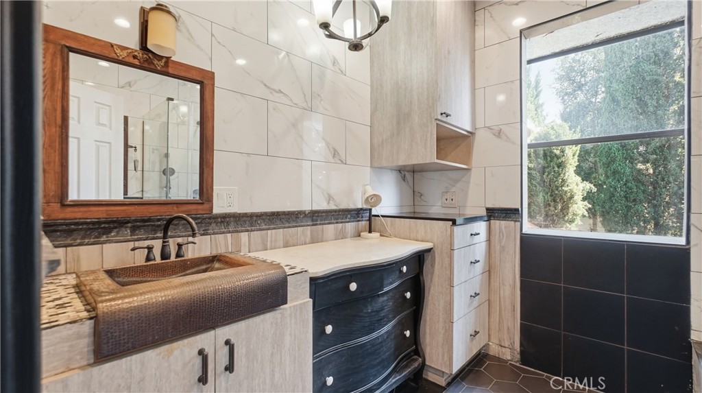10568 Foothill Boulevard Sylmar, CA 91342 - Photo 14 of 34 a bathroom with a sink and a mirror
