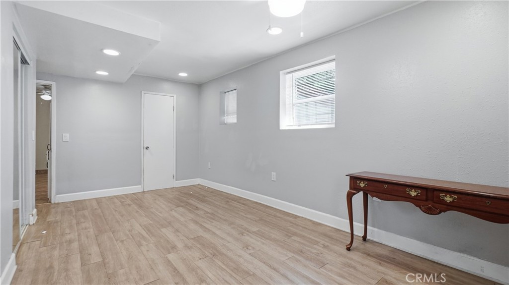 10568 Foothill Boulevard Sylmar, CA 91342 - Photo 21 of 34 a view of an empty room with wooden floor