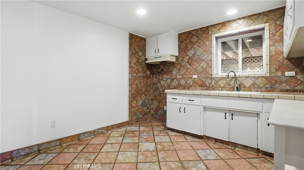 10568 Foothill Boulevard Sylmar, CA 91342 - Photo 22 of 34 a bathroom with a sink a vanity and a mirror
