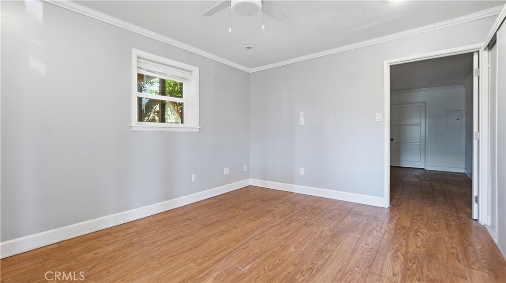 10568 Foothill Boulevard Sylmar, CA 91342 - Photo 25 of 34 an empty room with wooden floor and windows