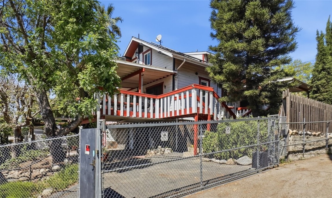 10568 Foothill Boulevard Sylmar, CA 91342 - Photo 5 of 34 a view of a house with wooden fence