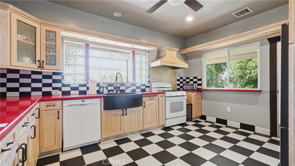 10568 Foothill Boulevard Sylmar, CA 91342 - Photo 9 of 34 a kitchen with a stove a sink and a refrigerator