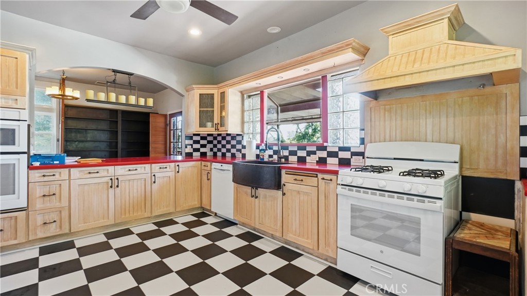 10568 Foothill Boulevard Sylmar, CA 91342 - Photo 10 of 34 a kitchen with stove cabinets and window