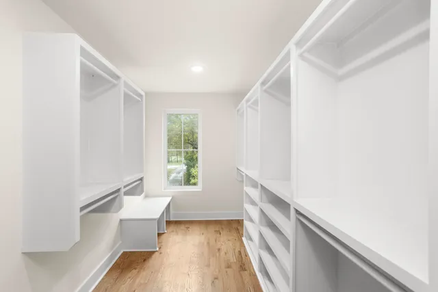 a view of a kitchen with a sink and dishwasher a refrigerator with wooden floor