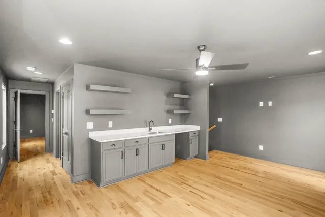 a view of roof deck with wooden floor and fence