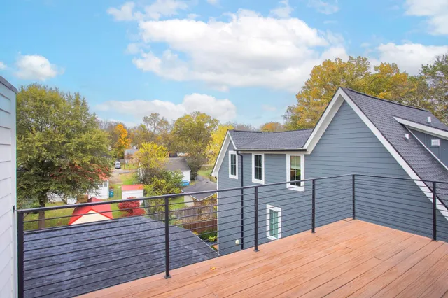 a view of a roof deck with wooden floor and fence
