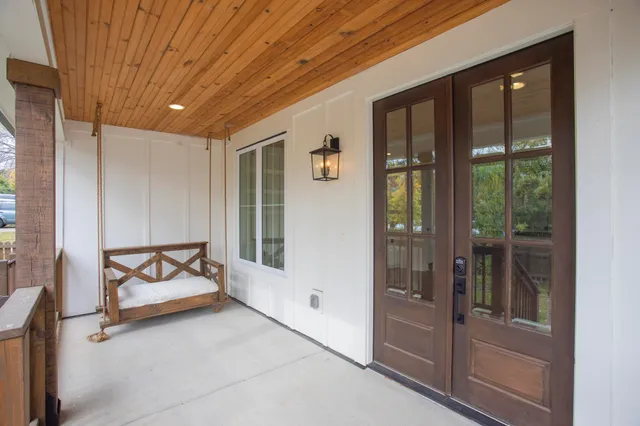 a spacious bedroom with a large bed and glass door