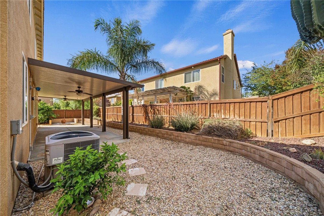 650 Winter Pine Street Beaumont, CA 92223 - Photo 30 of 32 a porch with a table and chairs next to a yard