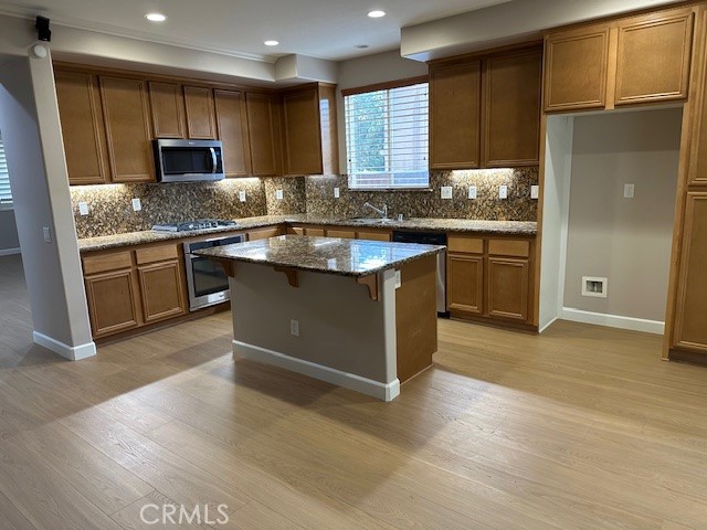 650 Winter Pine Street Beaumont, CA 92223 - Photo 3 of 32 a kitchen with granite countertop a sink stove and refrigerator