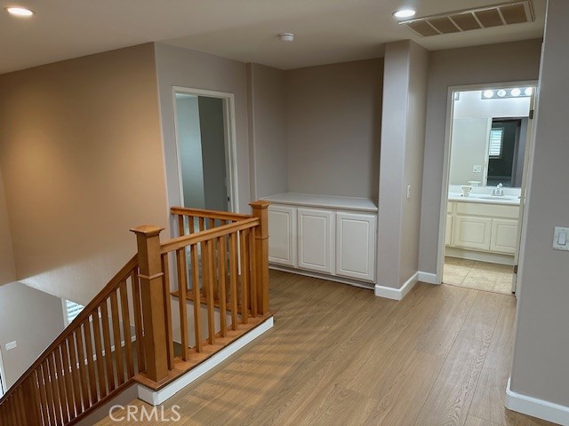 650 Winter Pine Street Beaumont, CA 92223 - Photo 7 of 32 a view of a hallway with wooden floor and staircase