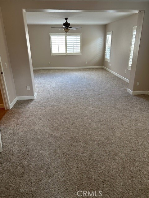 650 Winter Pine Street Beaumont, CA 92223 - Photo 8 of 32 an empty room with windows and chandelier fan