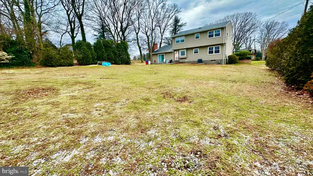 a yellow house with trees in front of it